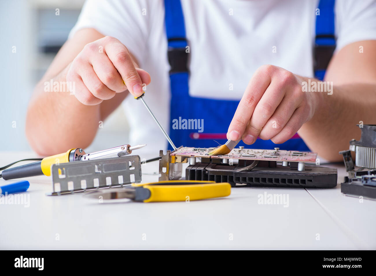 Computer repairman repairing desktop computer Stock Photo - Alamy