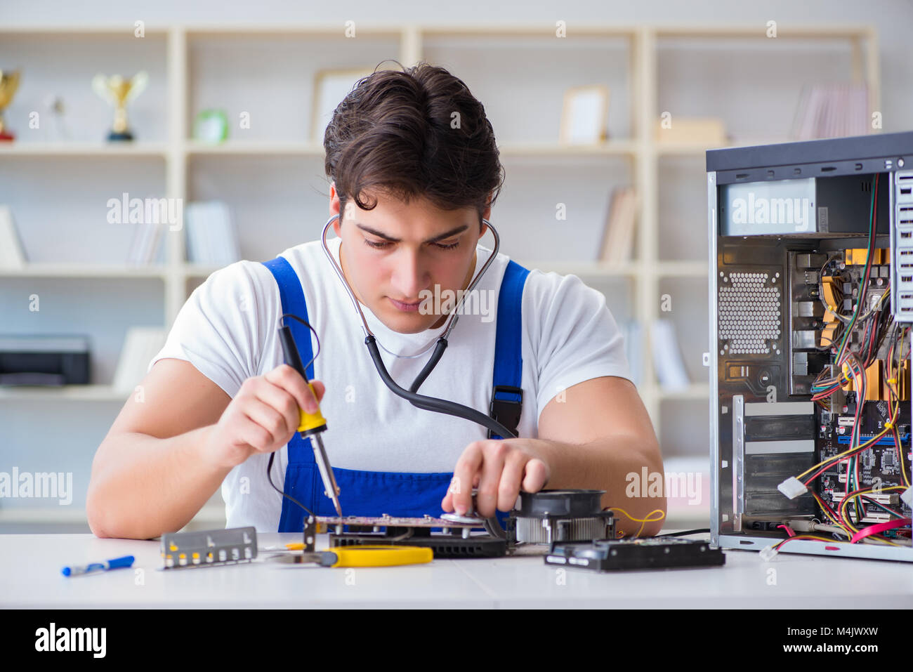 Computer repairman repairing desktop computer Stock Photo - Alamy
