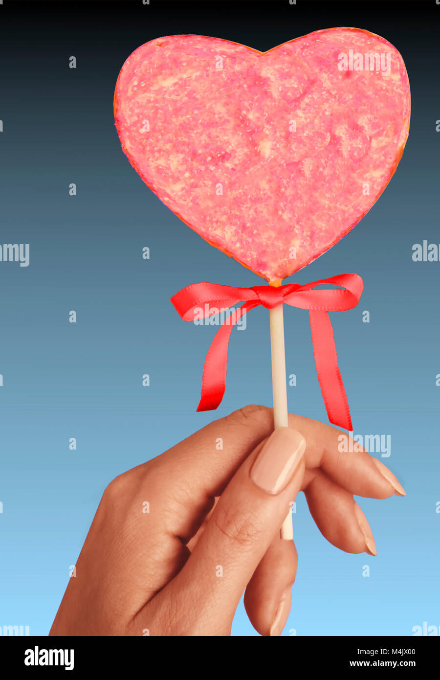 Hand holding heart cookie Stock Photo