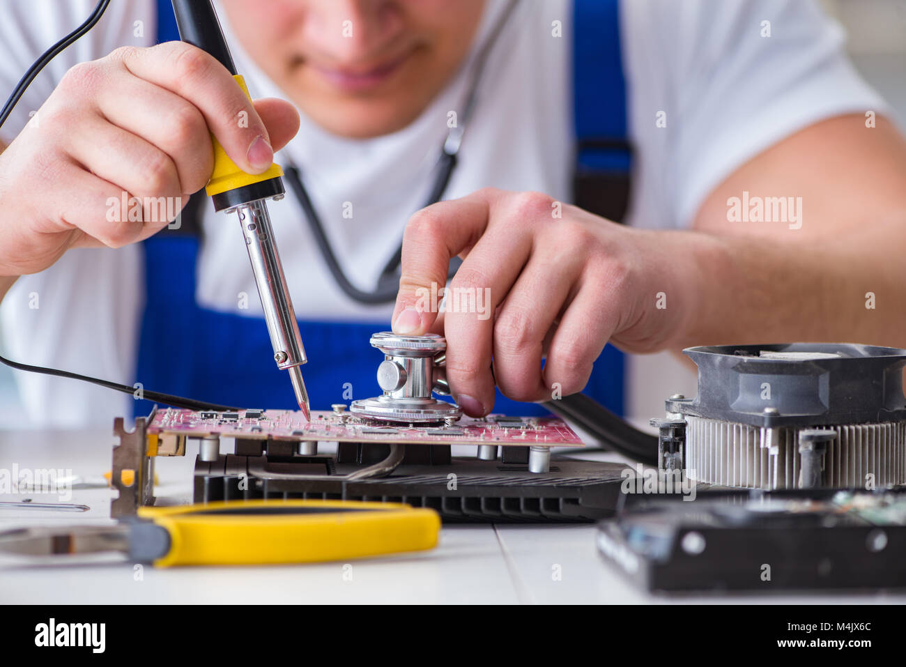 Computer repairman repairing desktop computer Stock Photo - Alamy