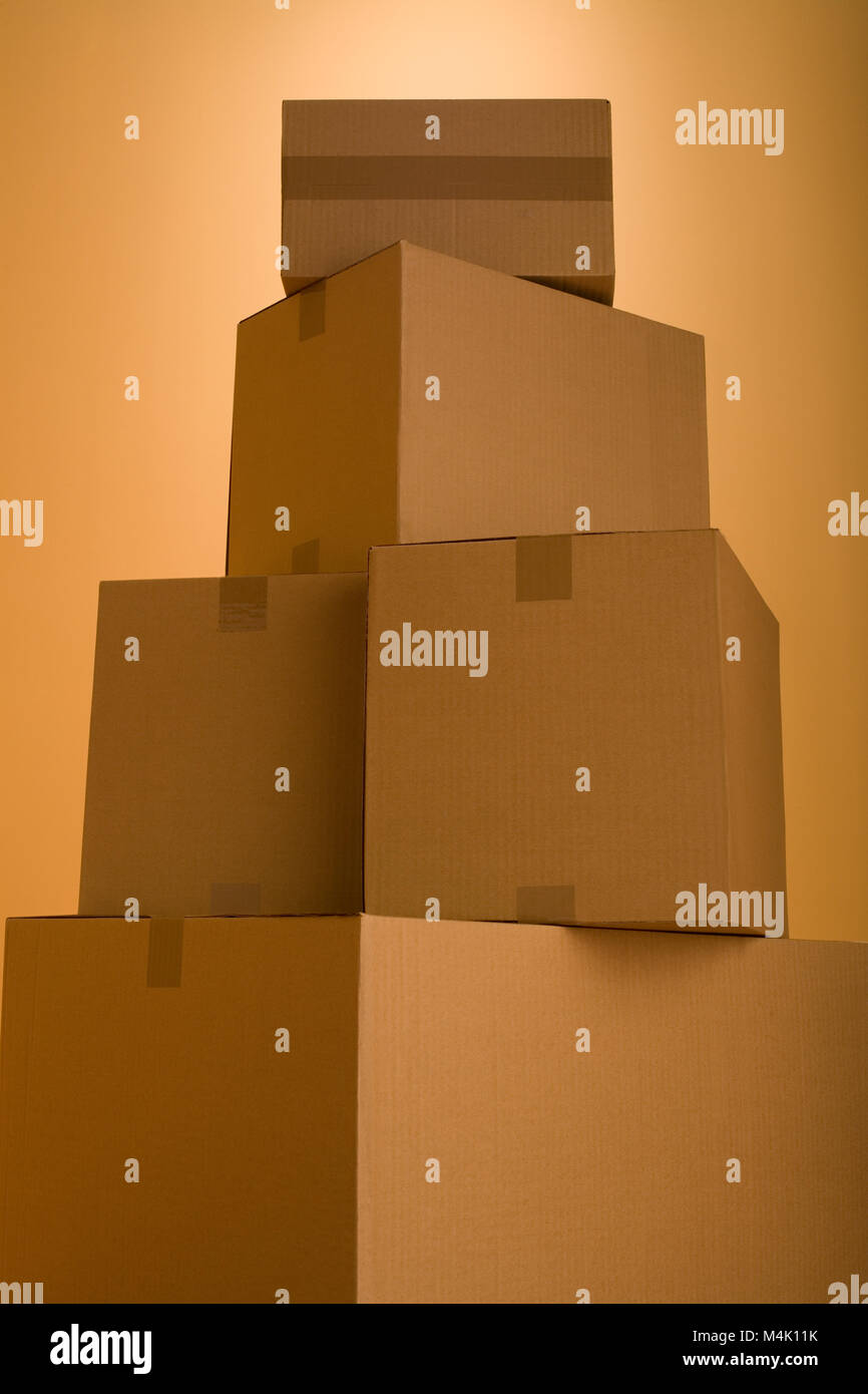 Boxes in an empty room representing concept of home moving Stock Photo
