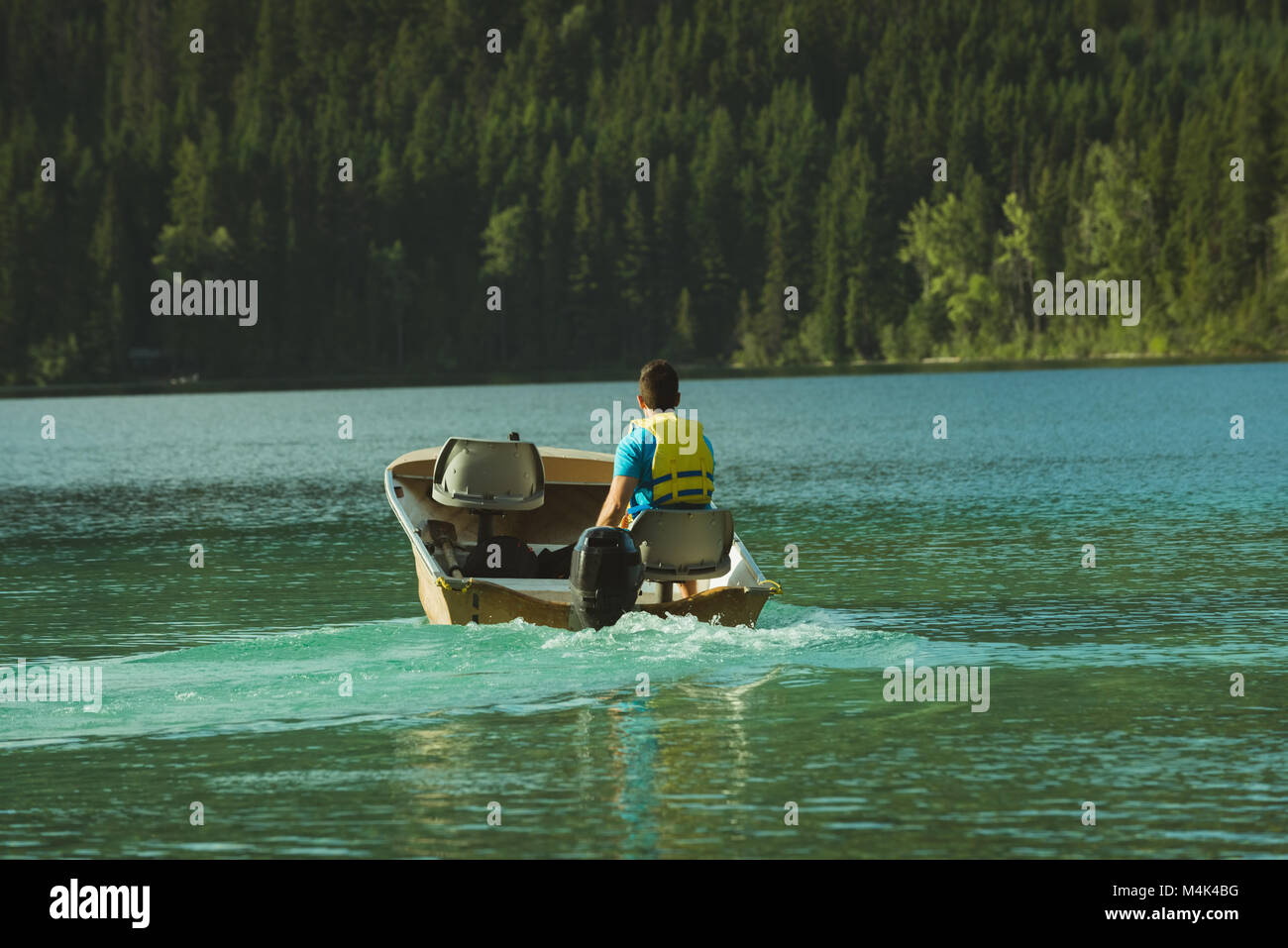 Man travelling on motorboat in a lake Stock Photo