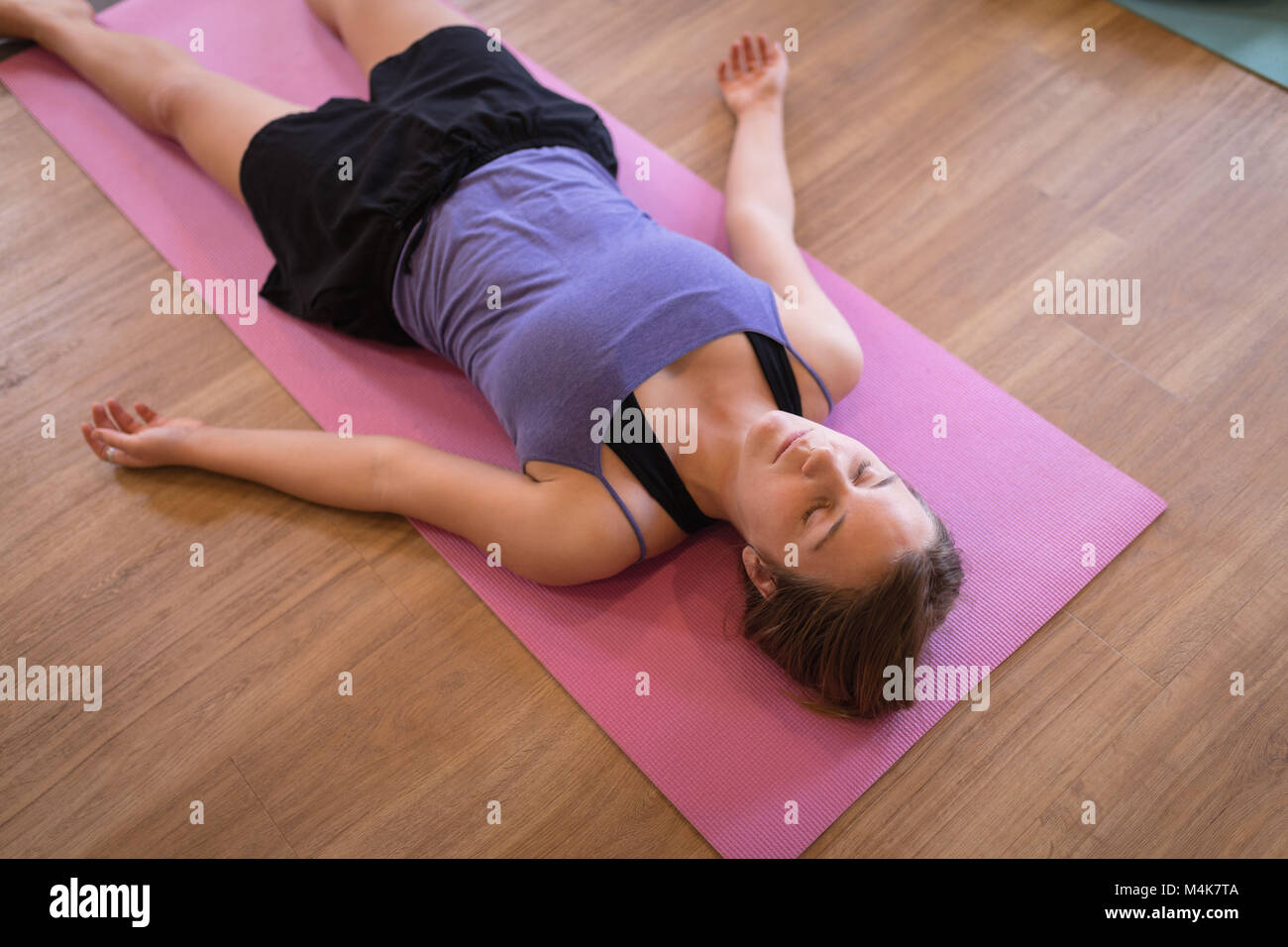 Woman meditating in fitness club Stock Photo