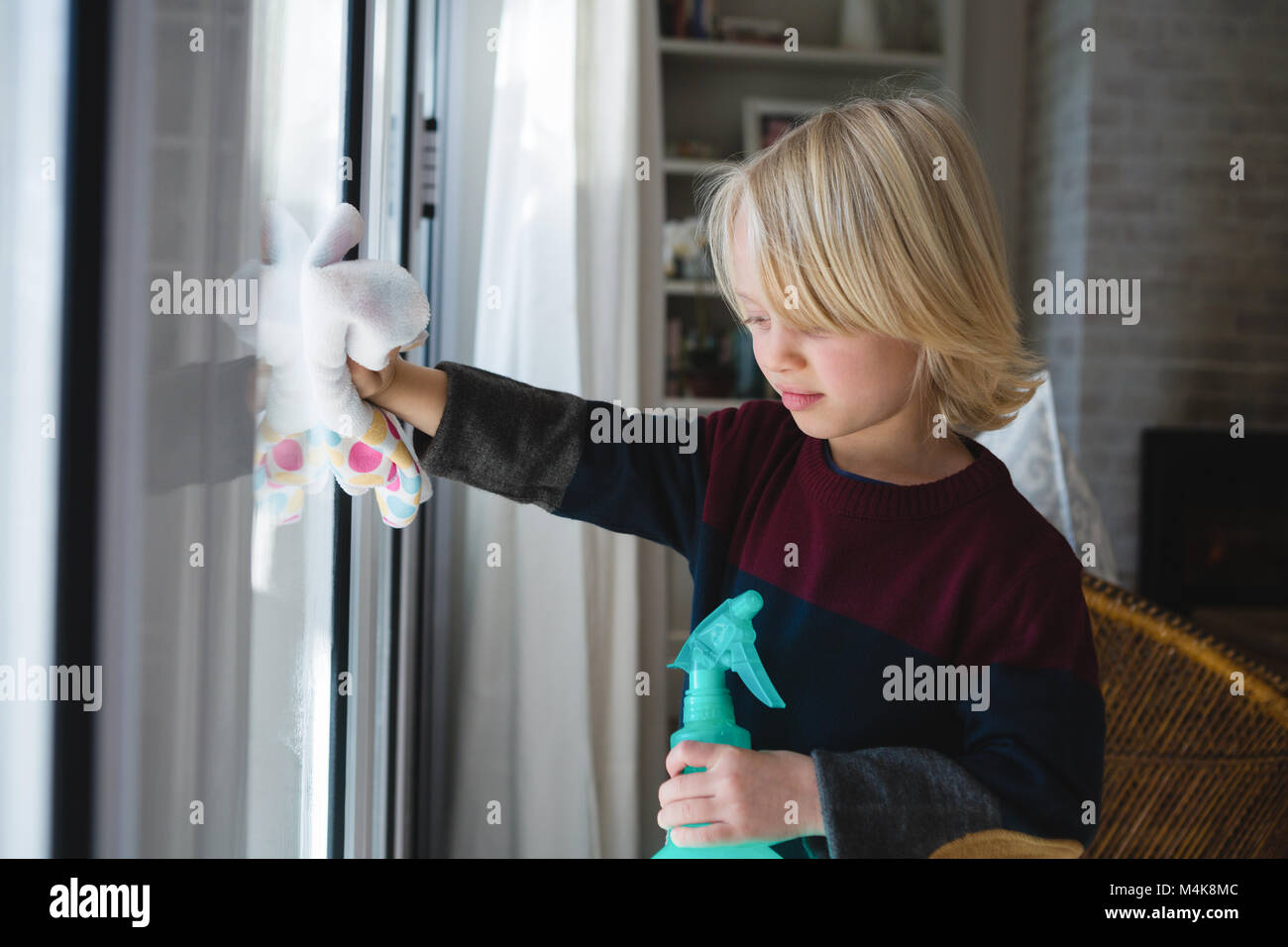 Boy cleaning window with rag cloth Stock Photo - Alamy