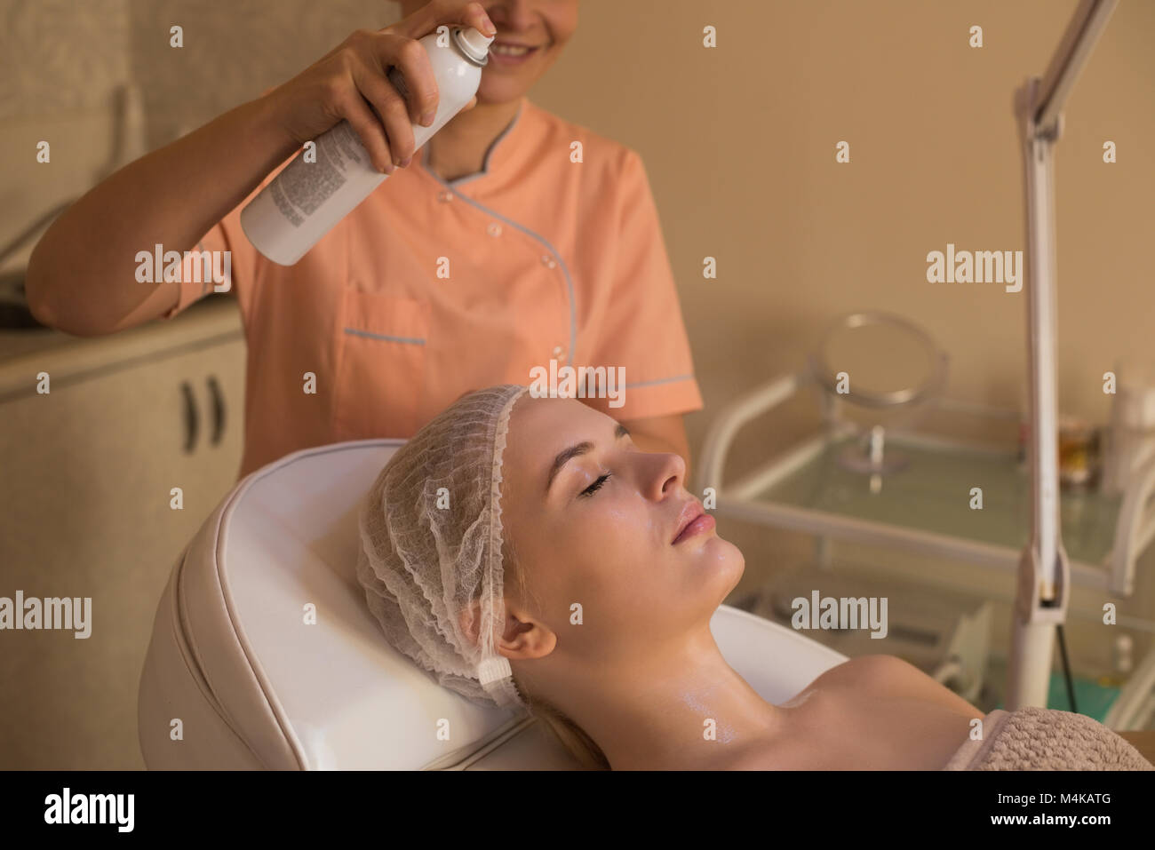 Beautician giving beauty treatment to female customer Stock Photo