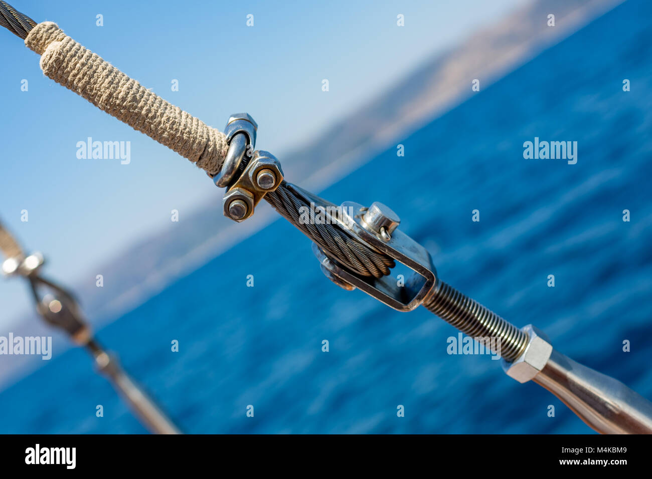 Diagonal ship metallic rope with nuts and bolts Stock Photo - Alamy