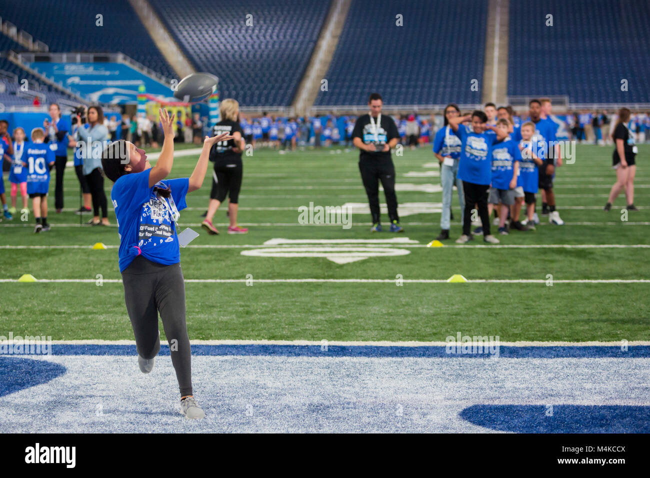 Detroit, Michigan - A girl catches a pass in the end zone as students participate in a physical activity and nutrition program at Ford Field. The prog Stock Photo