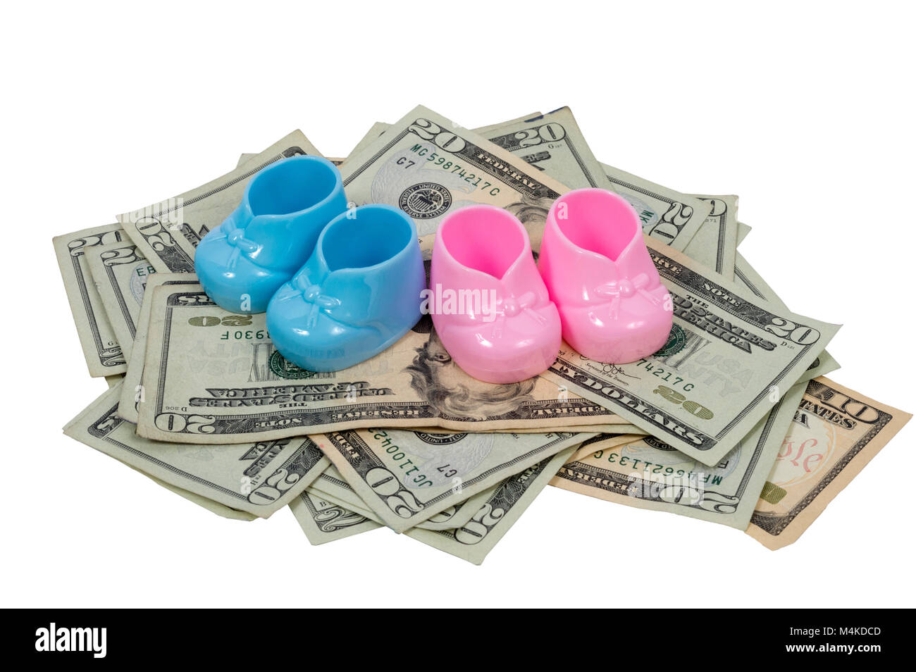 Ahorizontal shot of a  blue and pink baby booty sits on a pile of twenty and ten dollar bills on a white background. Stock Photo