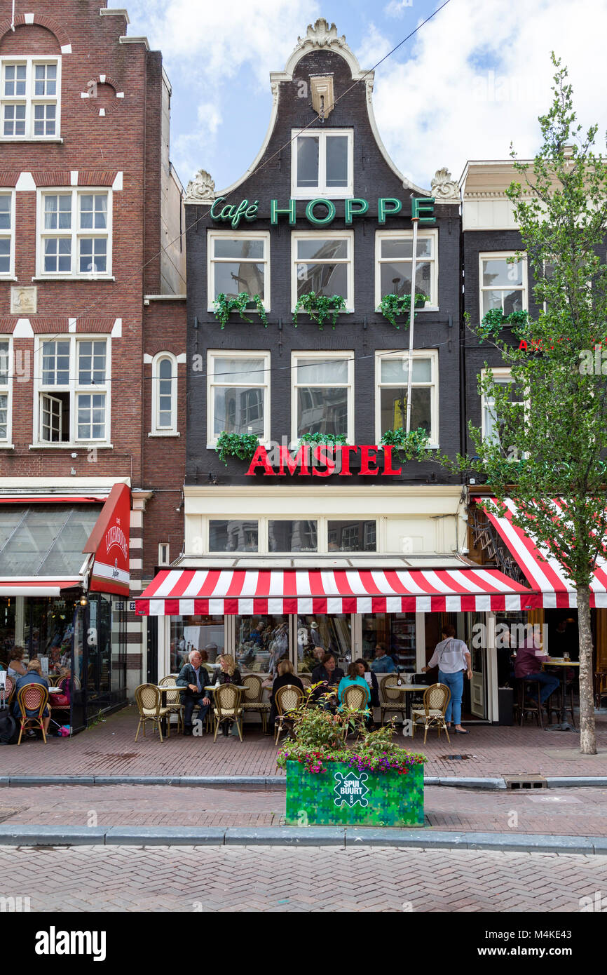 Cafe in Amsterdam with outdoor dining. Covered patio with red and white
