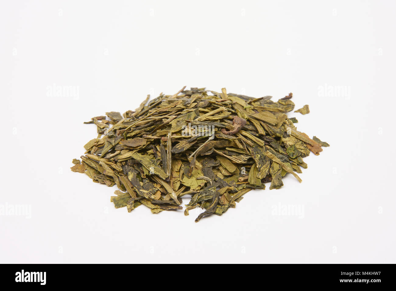Pile of green tea leaves on a white background - China Long Jing Xi Hu Stock Photo