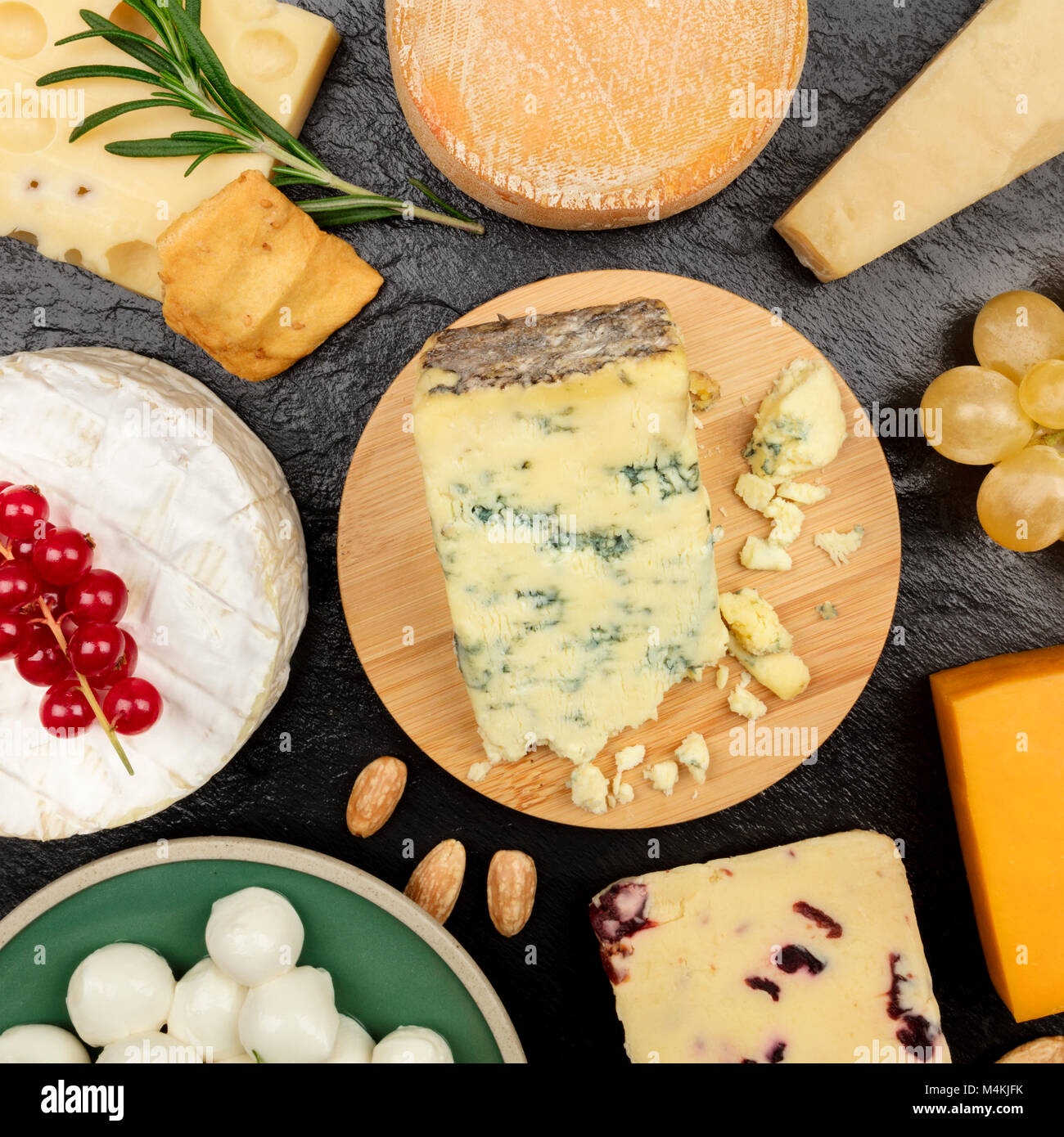 An Assortment Of Various Types Of Cheese Shot From Above On A Black 