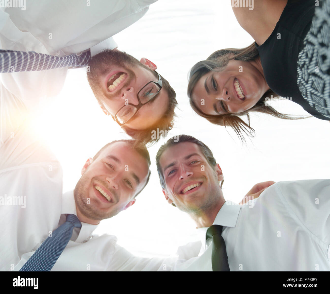 closeup.bottom view.successful business people with arms around each other's shoulders. Stock Photo