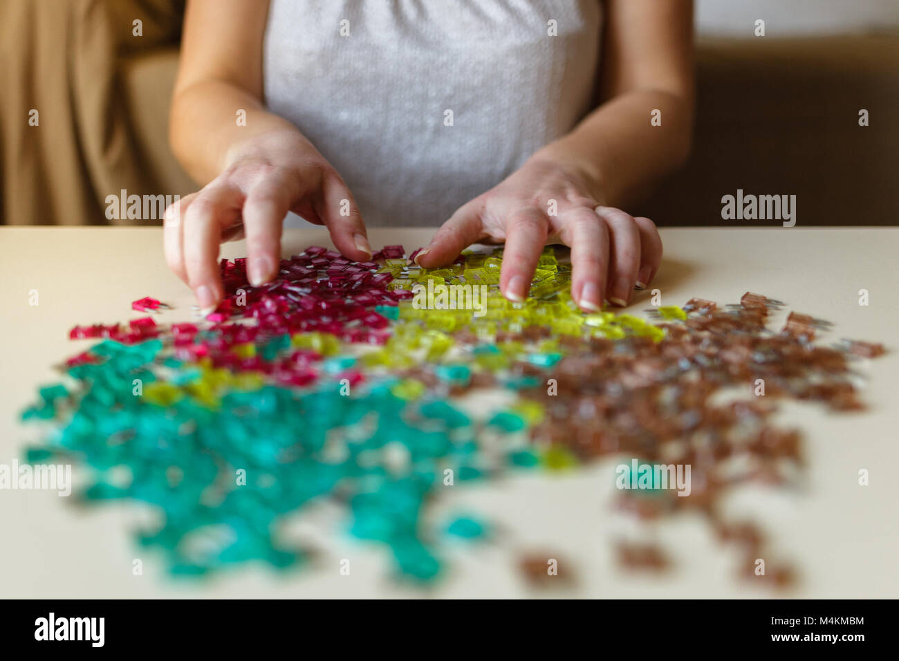 Woman hand sorting car electric parts colorful mini fuses on desk. Soft ...