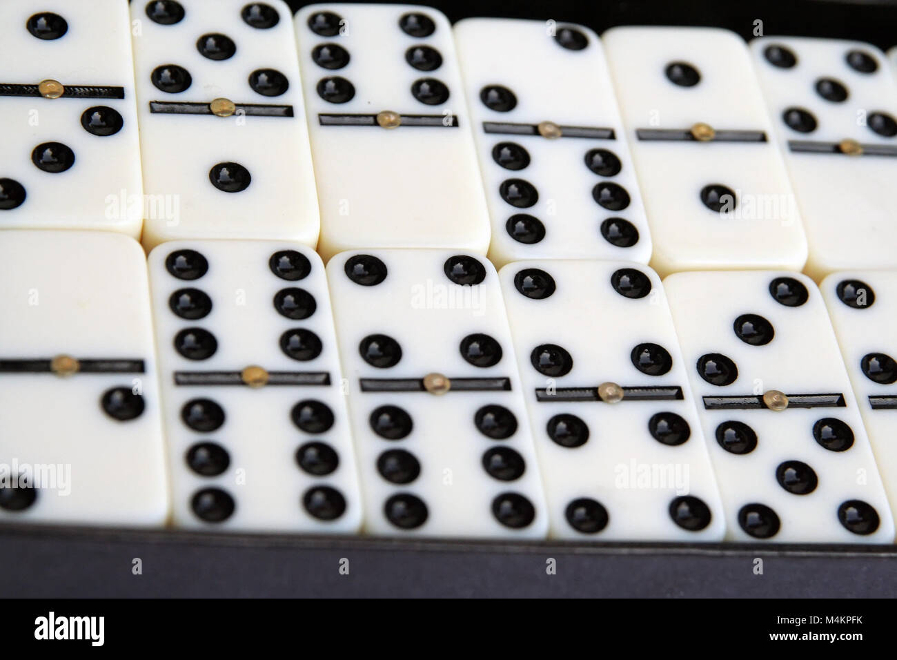 White marble dominoes. Pile of dominoes. White and black dominoes. Stock Photo