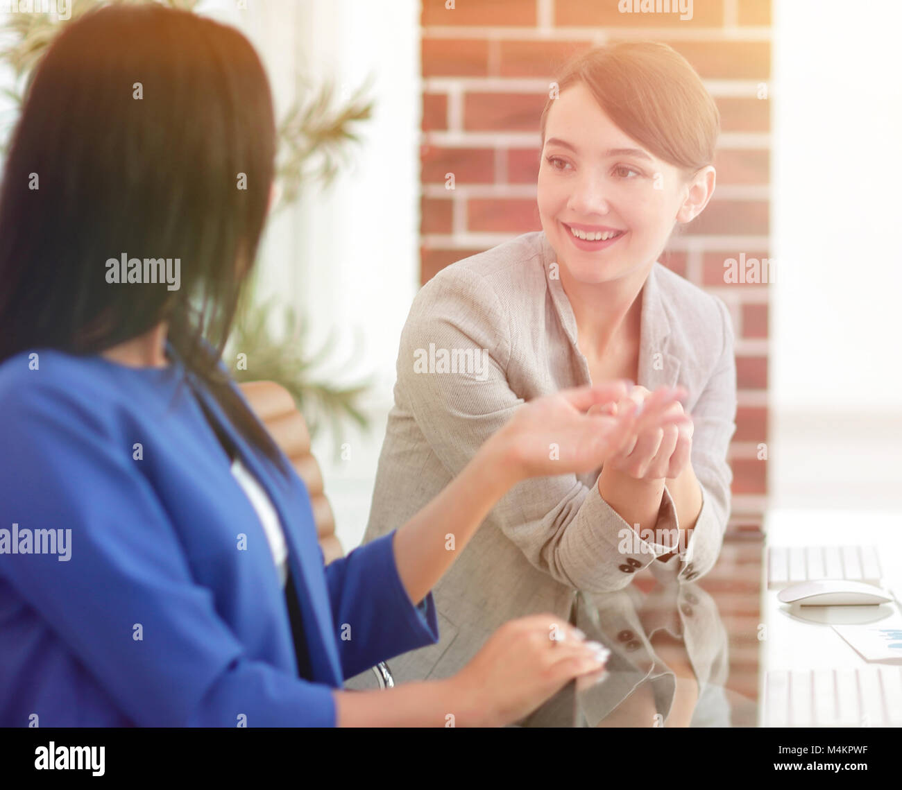 Two young businesswomen having meeting at office Stock Photo - Alamy