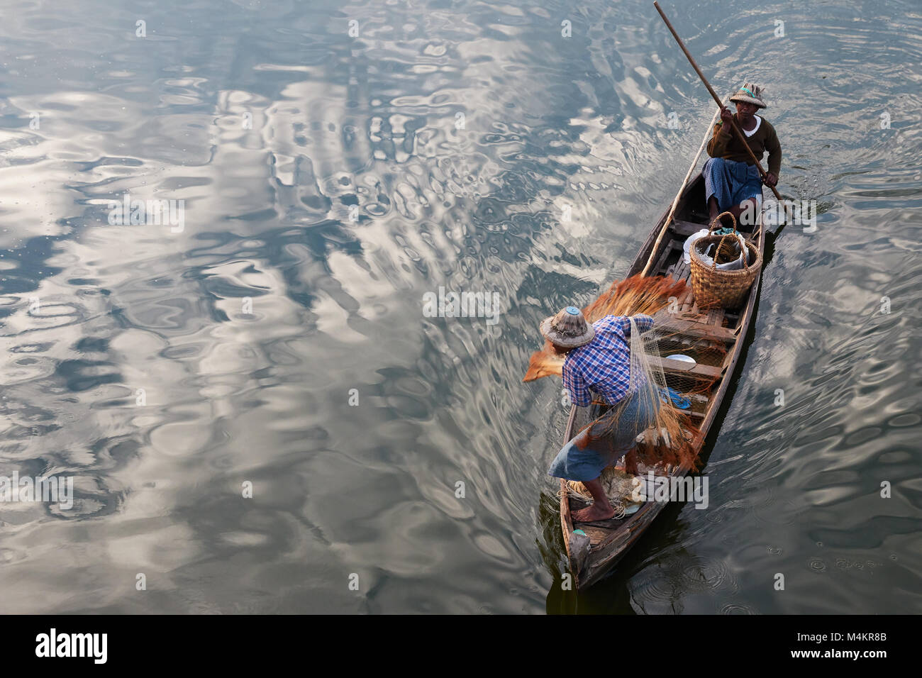 Fishermen using fishing net to catch fish at TaugThaMan Lake below