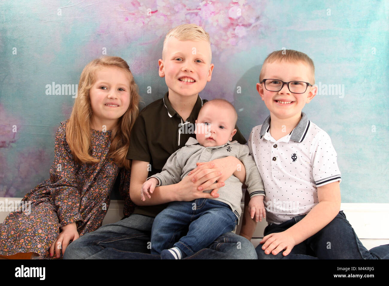 family life,four siblings happy and playing together, Big family Stock Photo