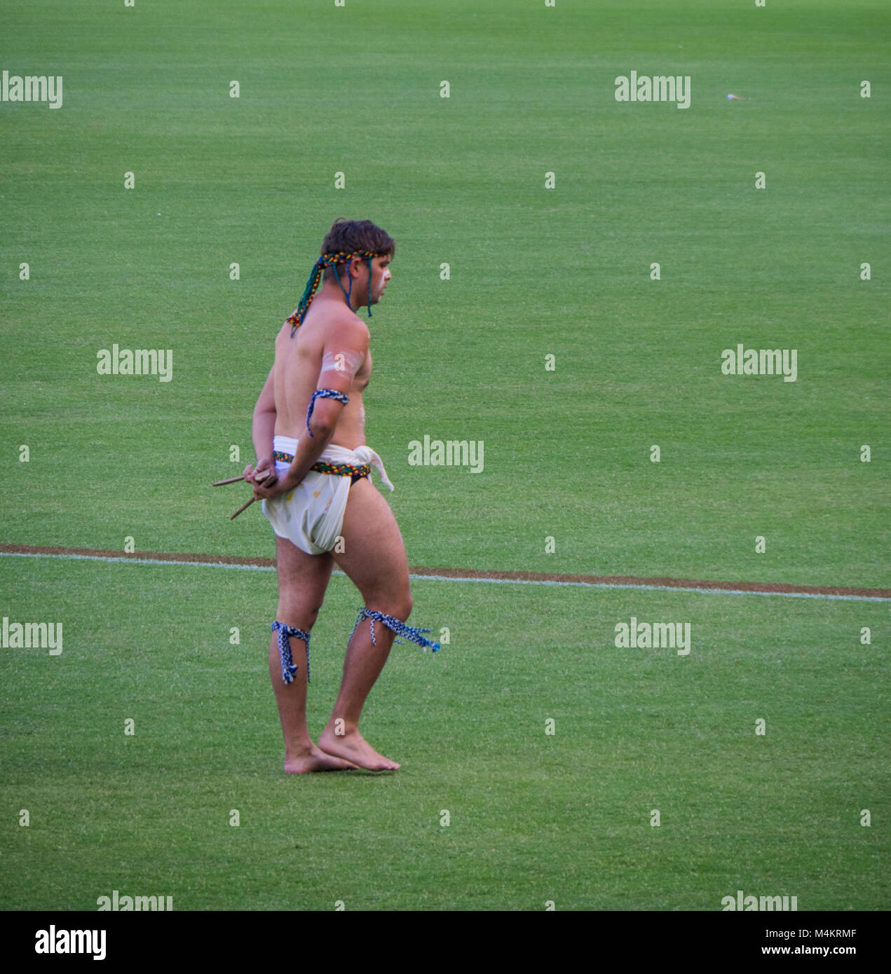 An indigenous man performing a traditional welcoming dance at Fremantle Dockers Women's game at Optus Stadium, Perth, WA, Australia. Stock Photo