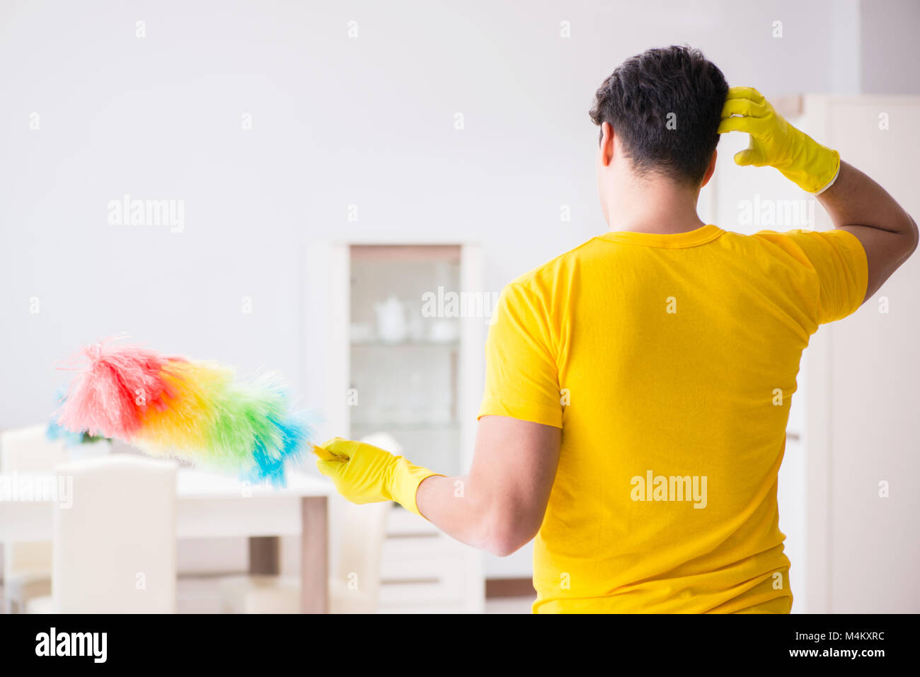Young man doing chores at home Stock Photo Alamy