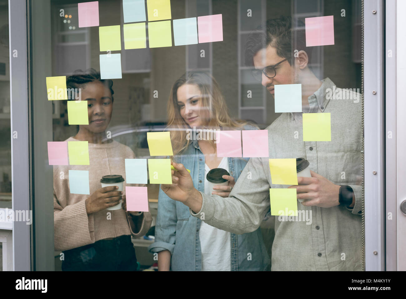 Business colleagues discussing over sticky notes Stock Photo - Alamy