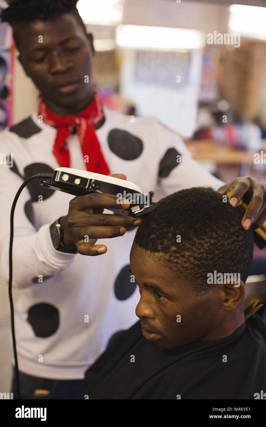 Barber trimming customer hair Stock Photo