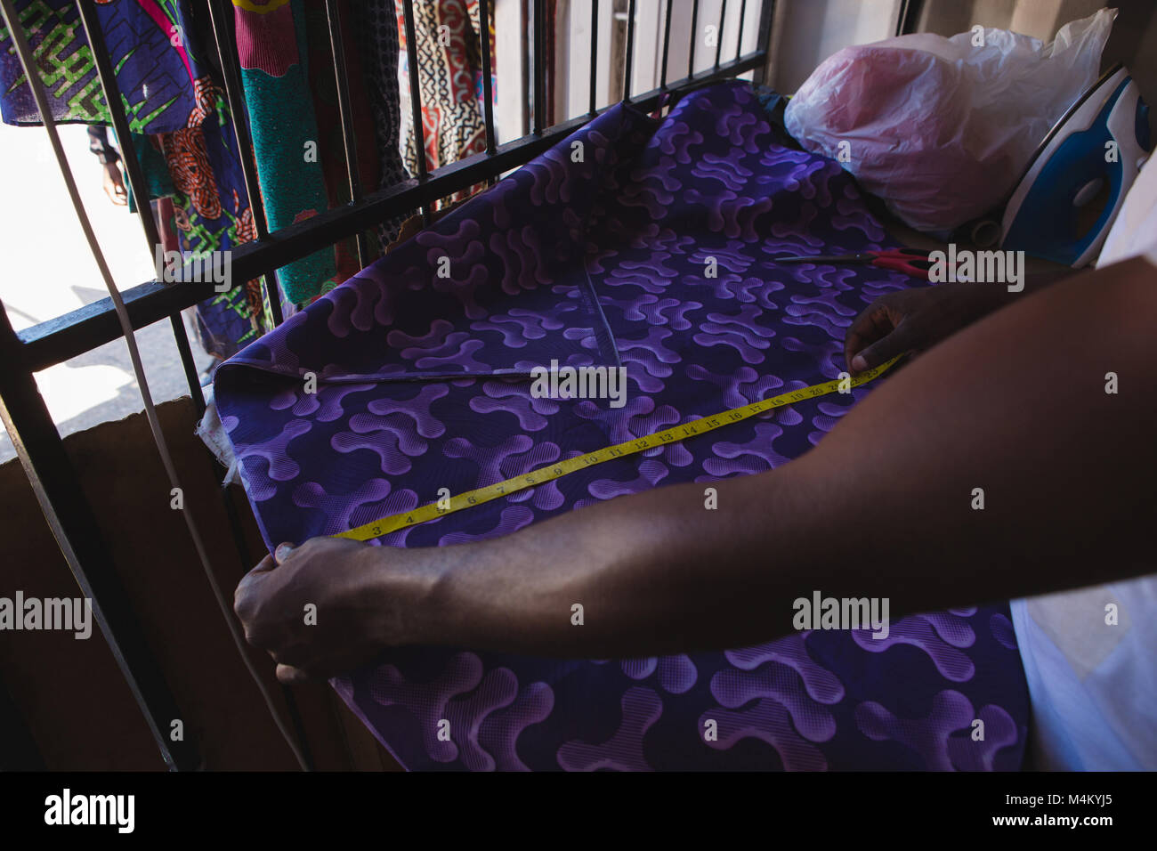 Tailor measuring a fabric Stock Photo Alamy