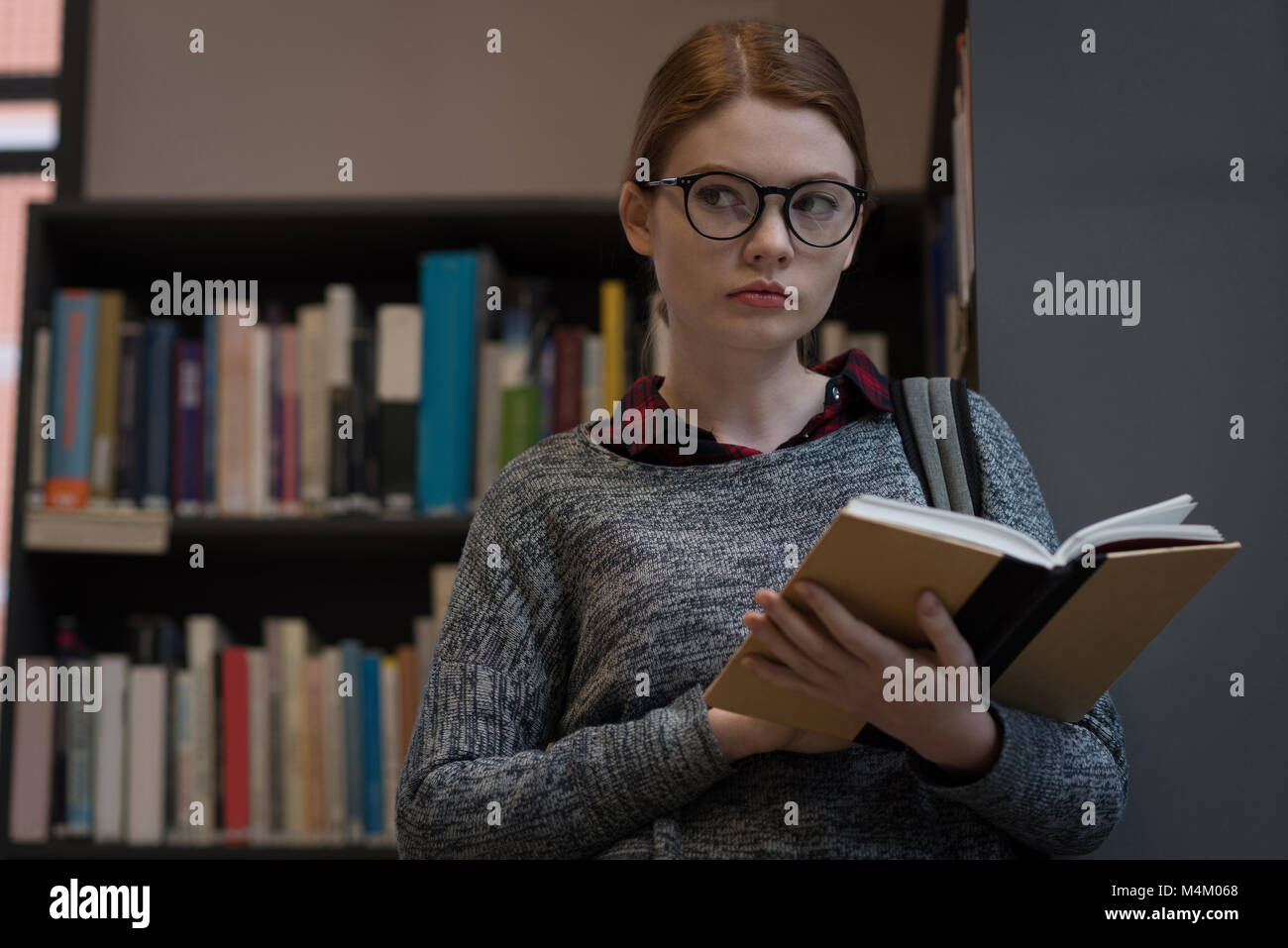 Young woman reading a book Stock Photo - Alamy
