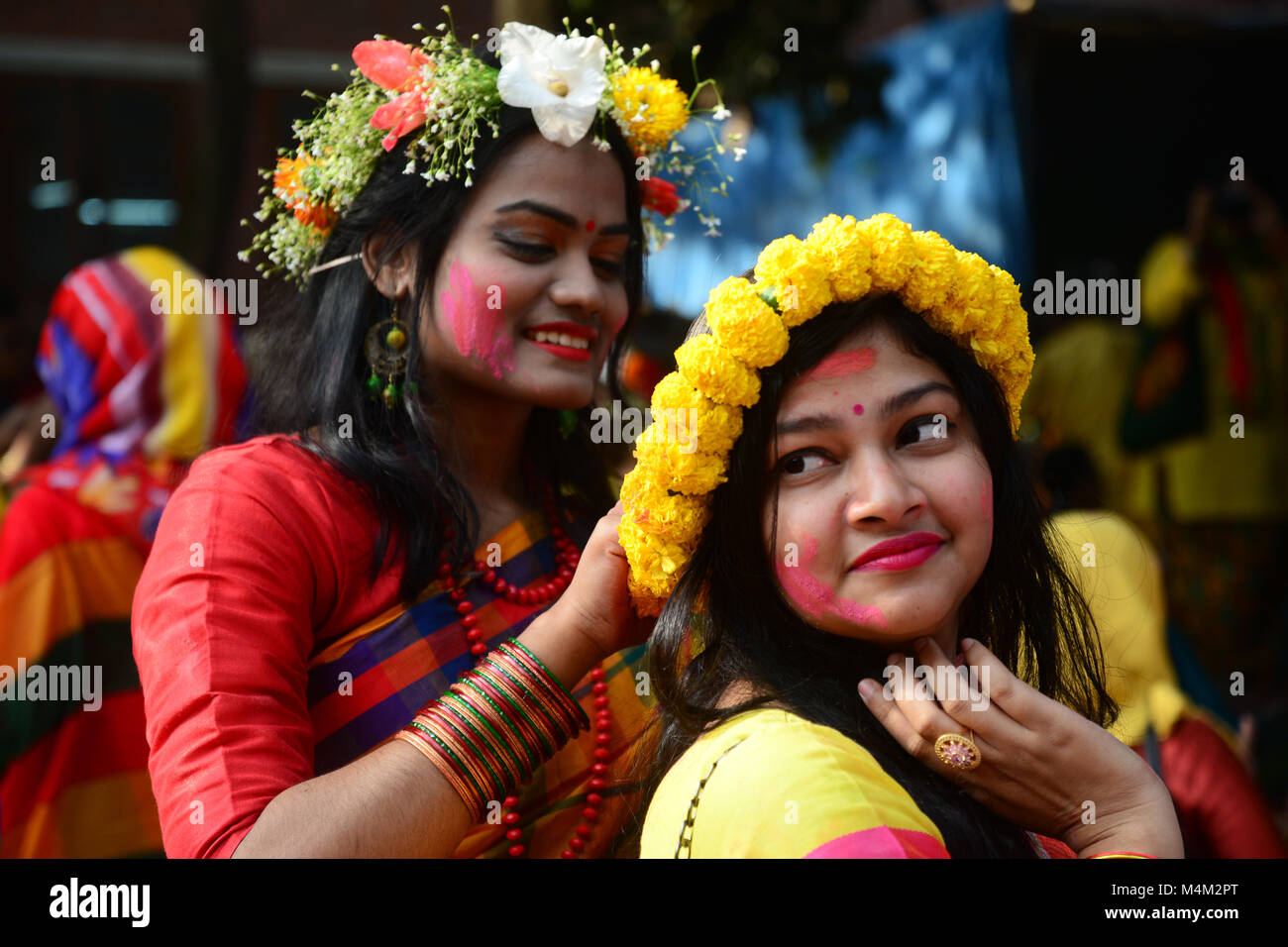 Bangladeshi women wearing traditional saris and ornate jewellery take
