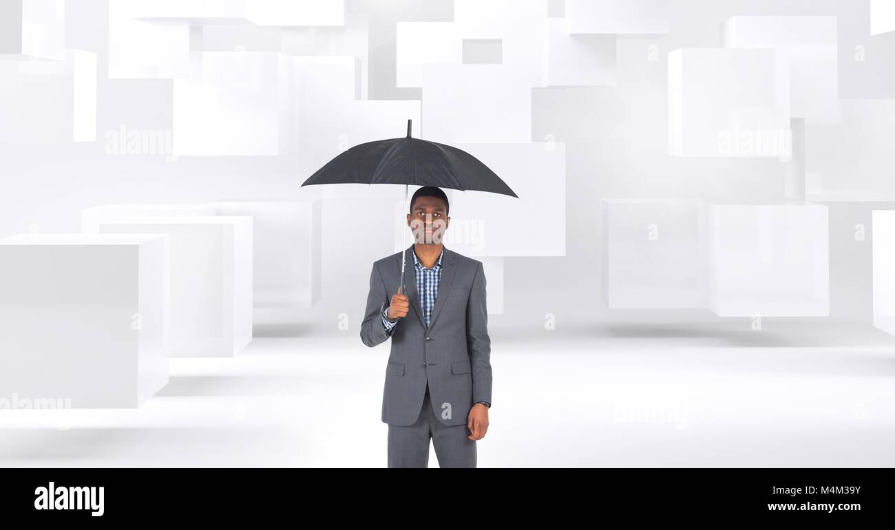 Man holding umbrella with cubes background Stock Photo