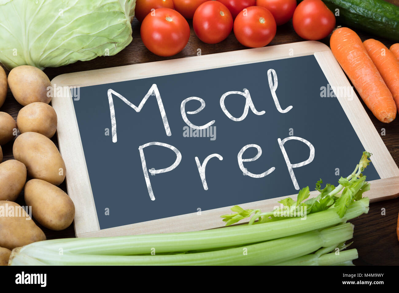 Elevated View Of Fresh Organic Vegetables With Meal Preparation Words Written On Slate Stock Photo