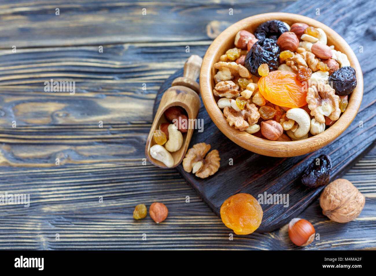 Nuts and dried fruit in a wooden bowl. Stock Photo