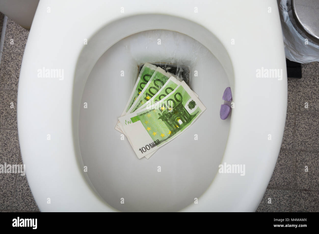 Elevated View Of One Hundred Euro Notes In The Toilet Bowl Stock Photo