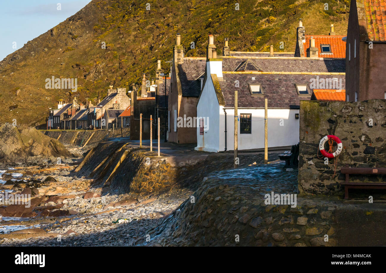 View of small picturesque seaside village Crovie, Aberdeenshire, Scotland, UK, with gable end old cottages on shore front Stock Photo