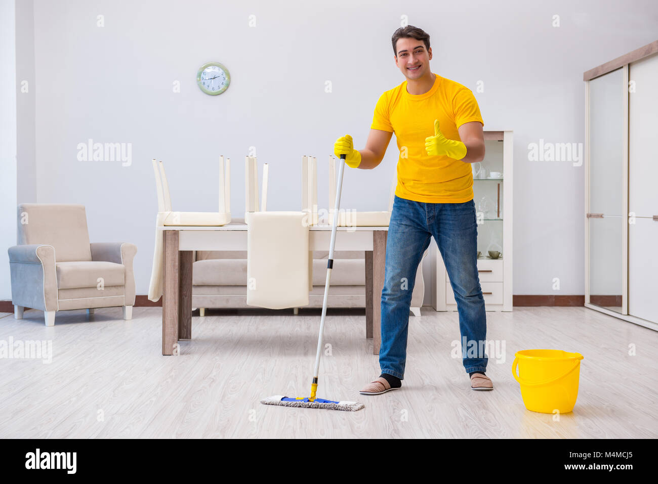 Young man doing chores at home Stock Photo - Alamy