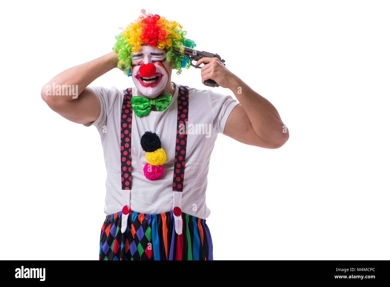 Funny clown with a gun pistol isolated on white background Stock Photo