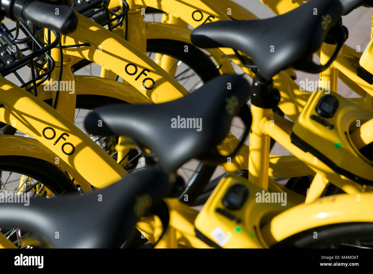A row of Ofo dock-less bicycle-sharing bikes in Tempe, Arizona, on February 3, 2018. Stock Photo