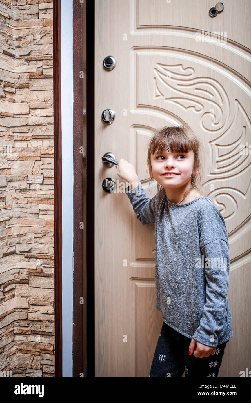 The Little Girl With A Scary Face Look At A Door Background