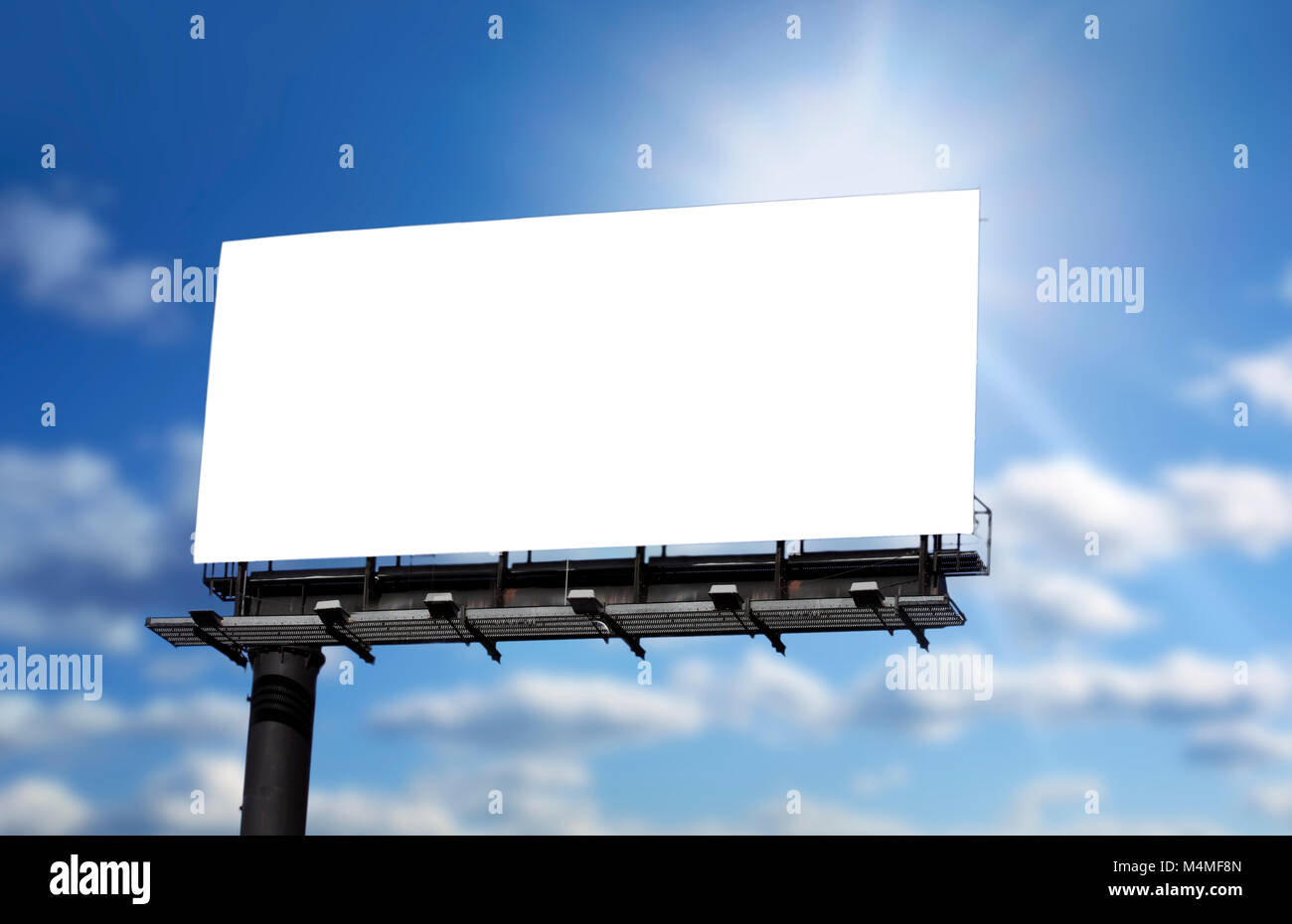 Blank billboard against blue sky, put your own text here Stock Photo