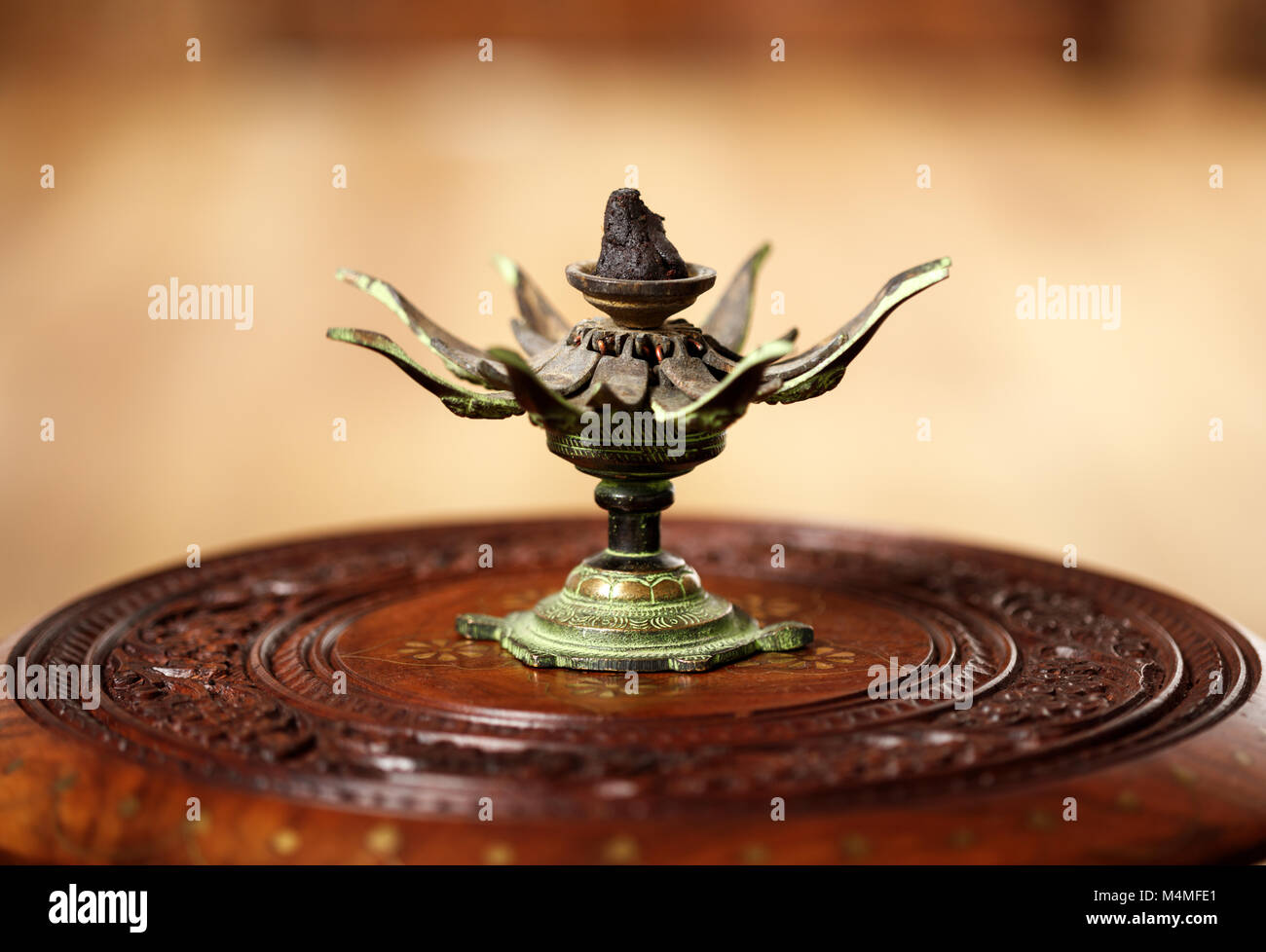 Traditional Indian yoga incense on a vintage lotus support Stock Photo