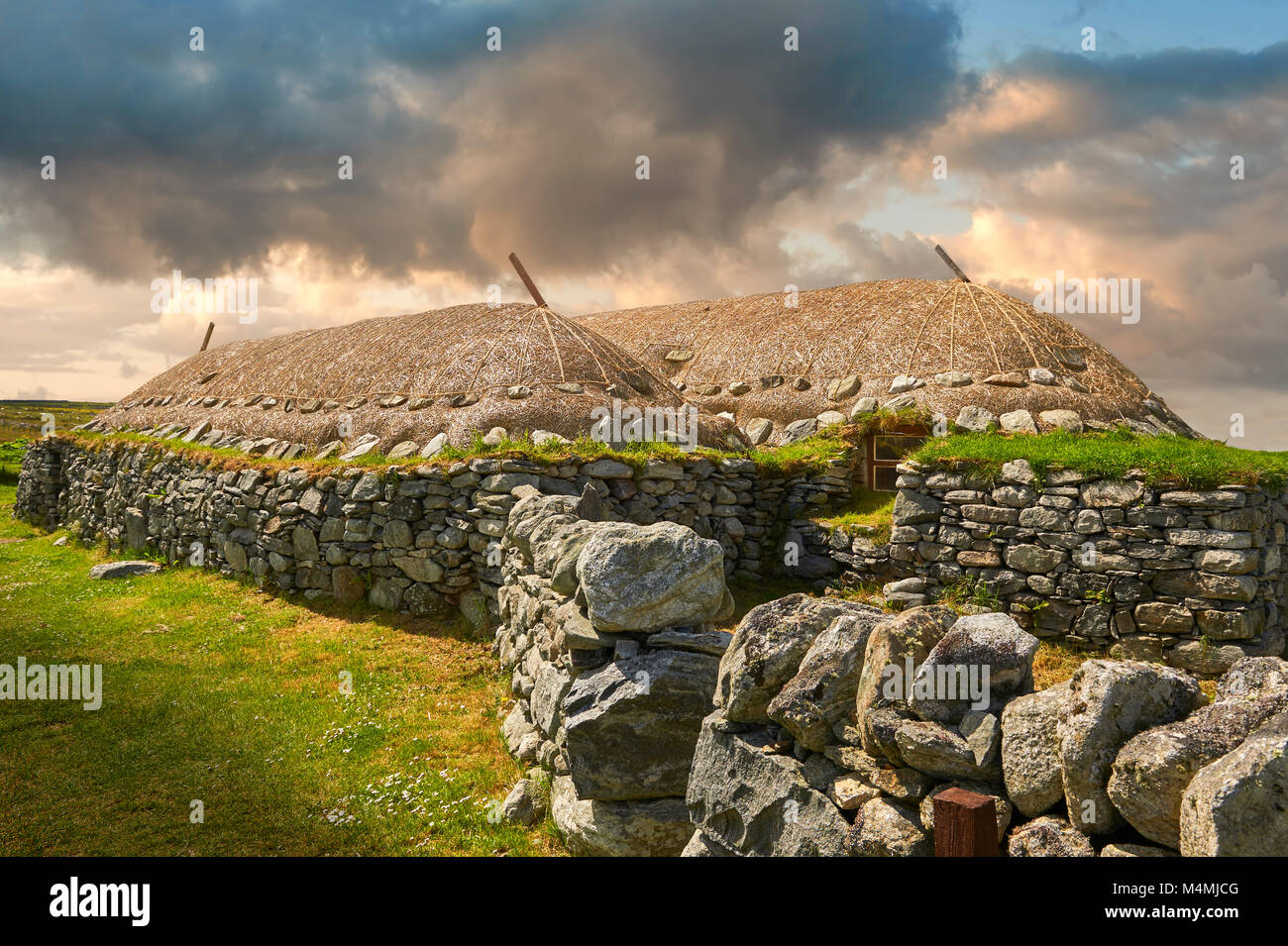 Picture & image of the exterior with stone walls and thatched roof of The historic Blackhouse, 24 Arnol, Bragar, Isle of Lewis, Scotland. Stock Photo