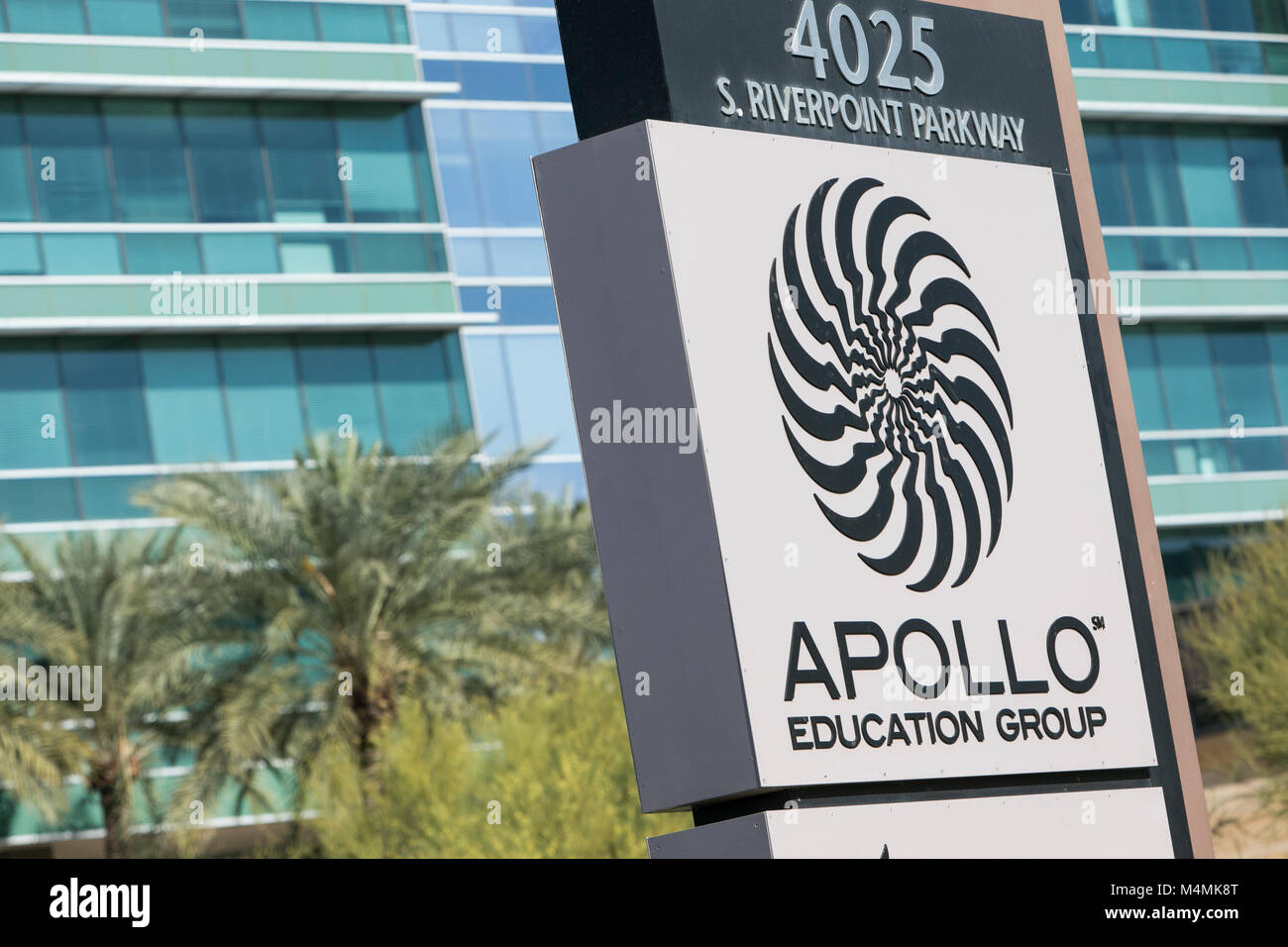 A logo sign outside of the headquarters of the Apollo Education Group