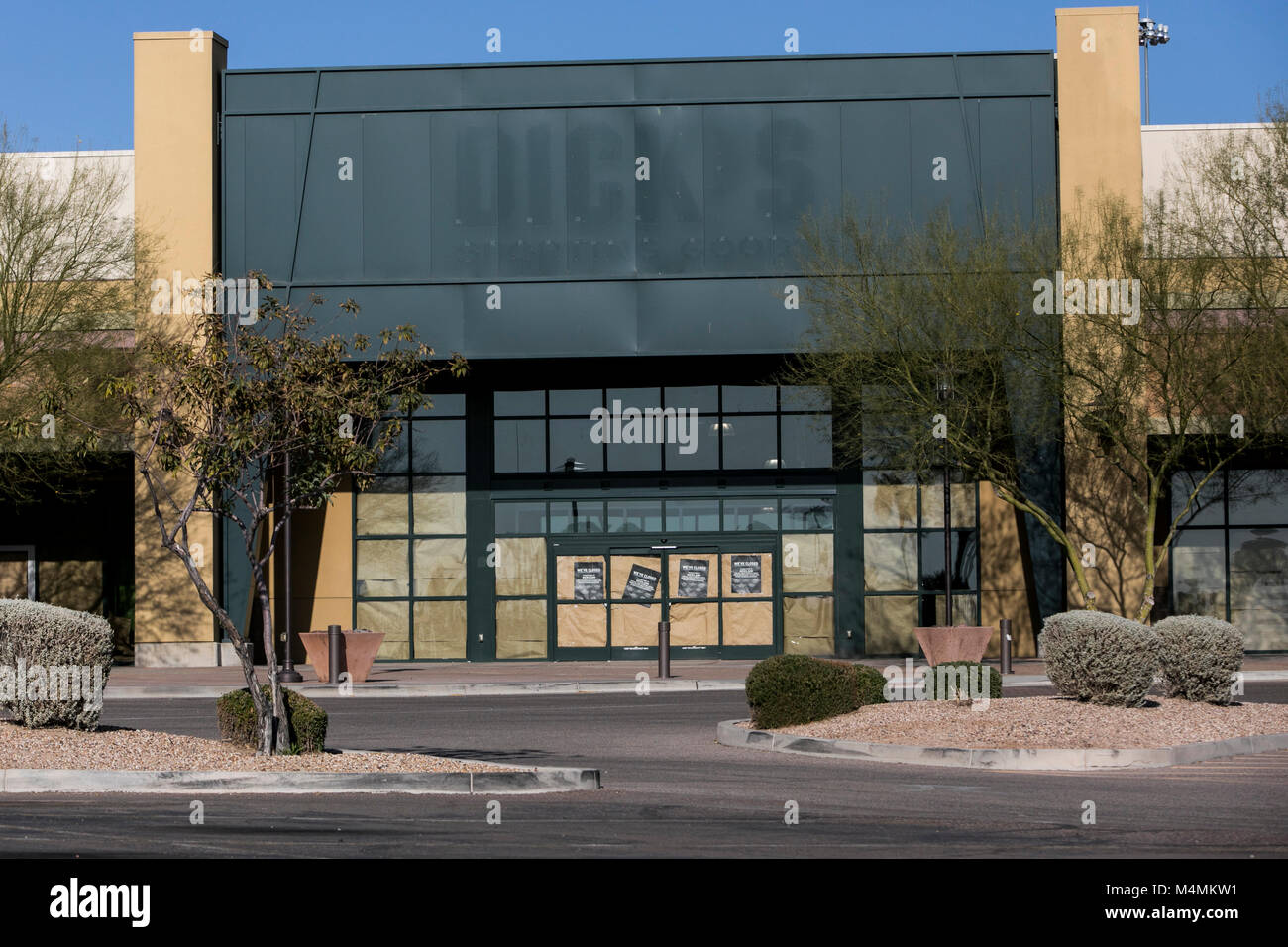 The faded outline of a logo sign outside of a now closed Dick's Sporting Goods, Inc., retail store in Mesa, Arizona, on February 3, 2018. Stock Photo