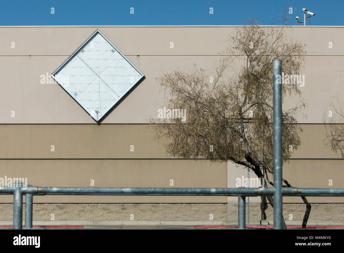 The outline of a logo sign outside of a recently closed Sam's Club warehouse club store in Scottsdale, Arizona, on February 4, 2018. Stock Photo