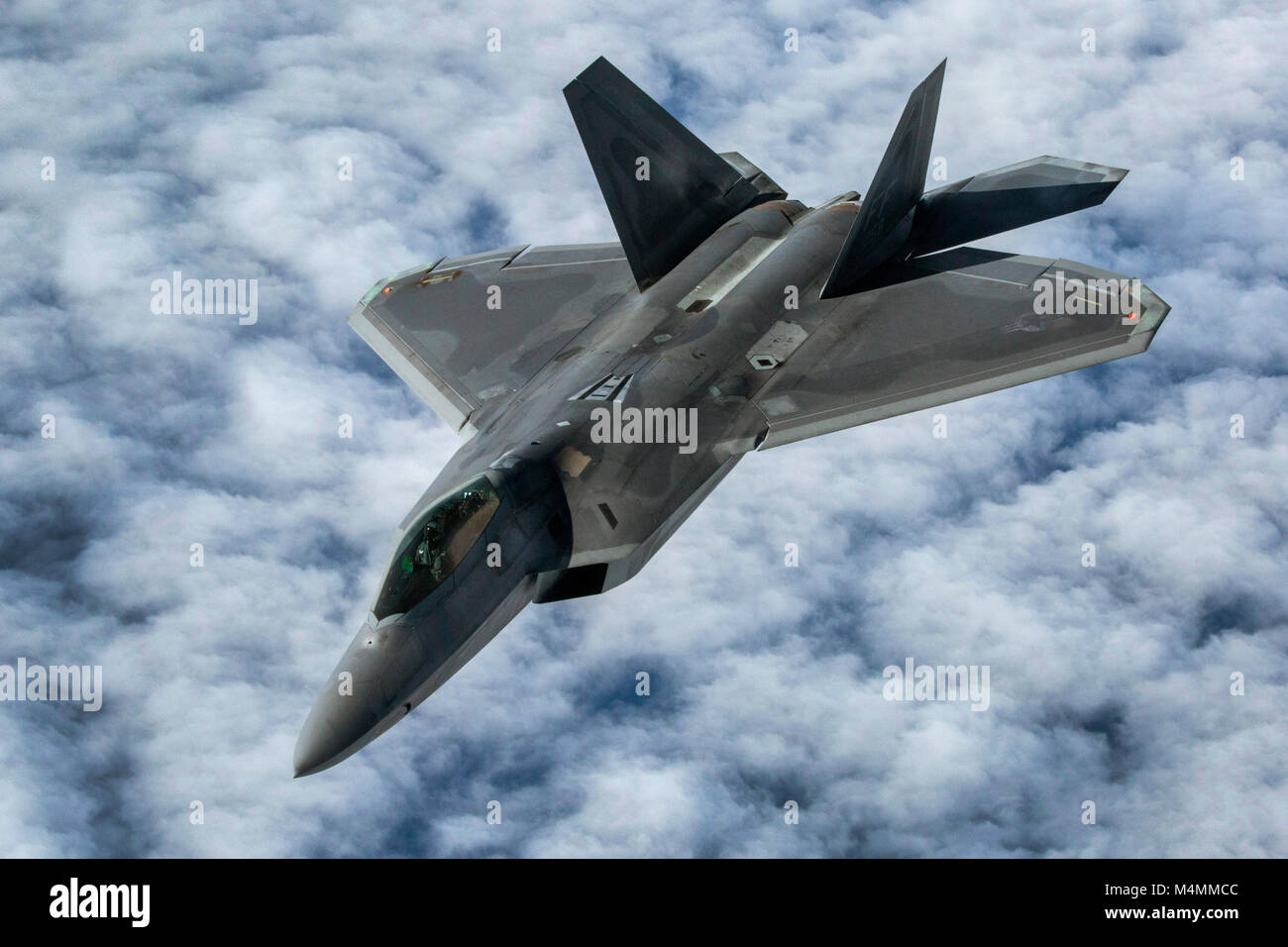 A U.S Air Force F-22 Raptor with the 1st Fighter Wing, Joint Base Langley-Eustis, Va., moves away after being refueled by a KC-10 Extender with the 78th Air Refueling Squadron, 514th Air Mobility Wing, over the Atlantic Ocean, Feb. 14, 2018. The 514th is an Air Force Reserve Command unit located at Joint Base McGuire-Dix-Lakehurst, N.J. (U.S. Air Force photo by Master Sgt. Mark C. Olsen) Stock Photo
