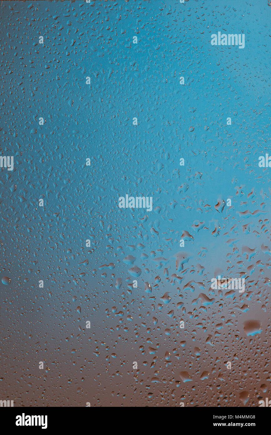 Natural water drops on glass blue colors Stock Photo - Alamy