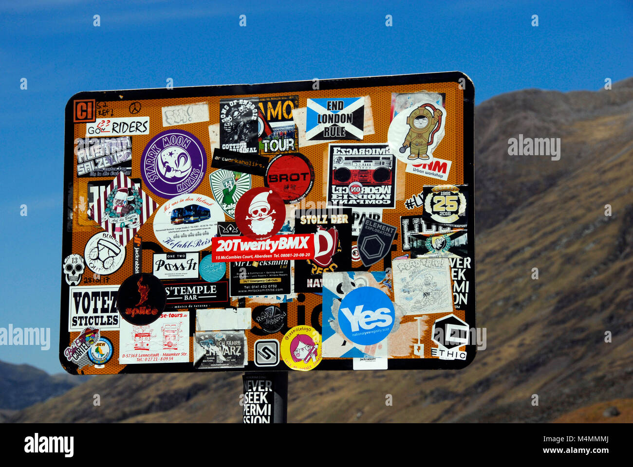 Roadside sign vandalized by irrelevant stickers. Scotland Stock Photo