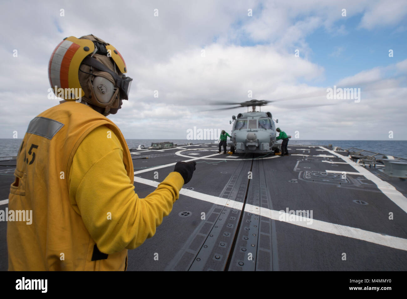 180210-N-SF984-0038 PACIFIC OCEAN (Feb. 10, 2018) Boatswain's Mate 3rd Class Aaliyah Terrell of Fort Worth, Texas, assigned to Arleigh Burke-class guided-missile destroyer USS Dewey (DDG 105), signals to an MH-60 Seahawk during flight operations. Dewey departed Naval Base San Diego to conduct operations in the Indo-Pacific Region, Feb. 6. Dewey, along with USS Sterett (DDG 104), will also support the Wasp Expeditionary Strike Group deployment in order to advance U.S. Pacific Fleet's Up-Gunned ESG concept and will train with forward-deployed amphibious ships across all mission areas.  (U.S. Nav Stock Photo