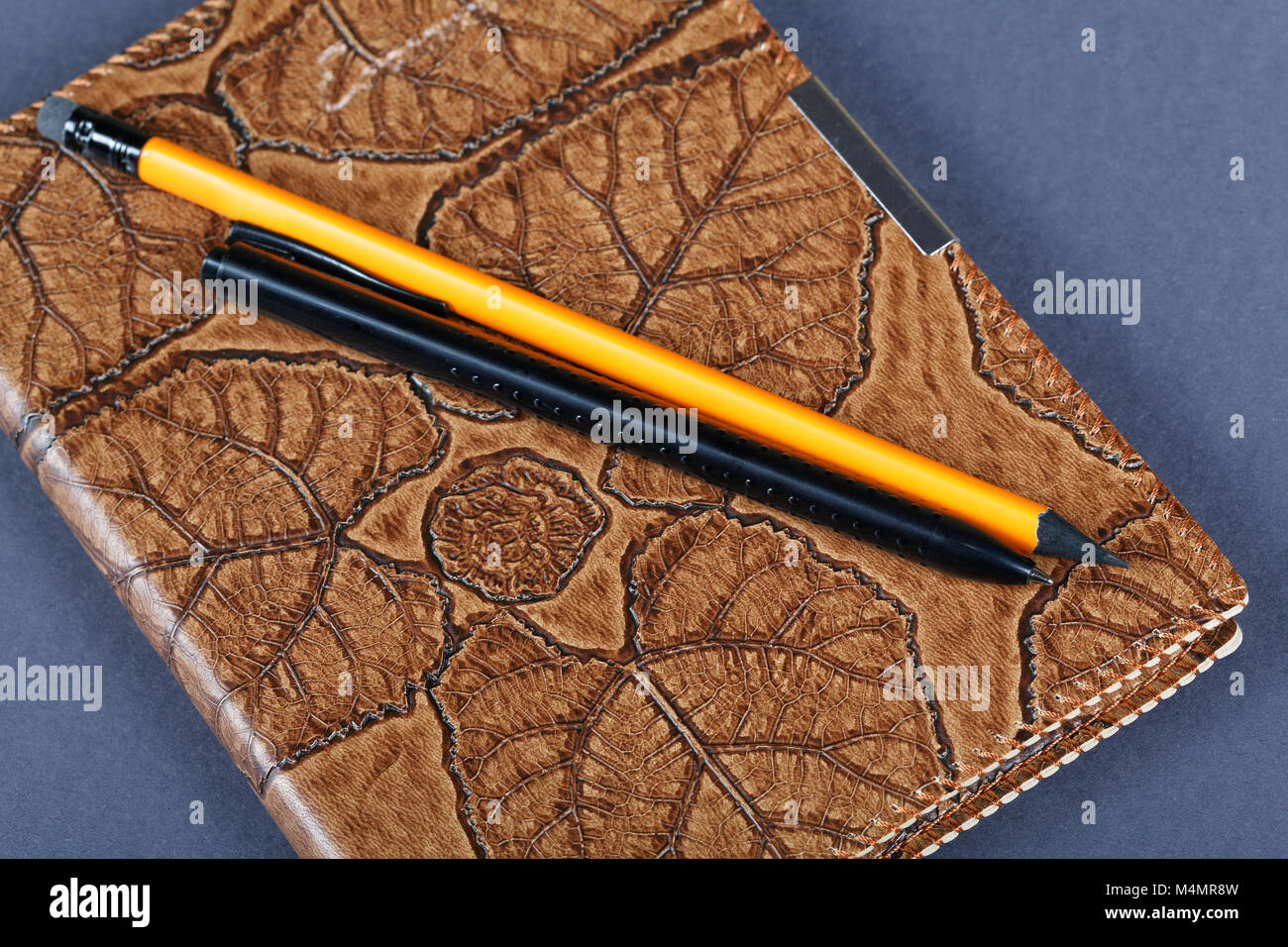 notebooks in leather covers and a pencil close up Stock Photo