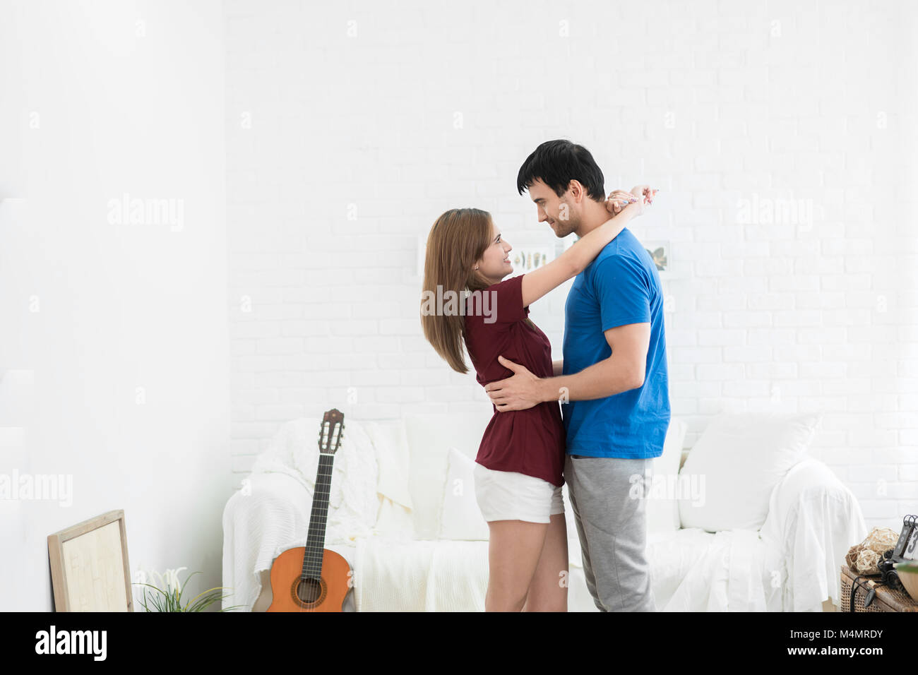 Romantic Happy Young Couple Relax At Modern Home Indoors And Have Fun