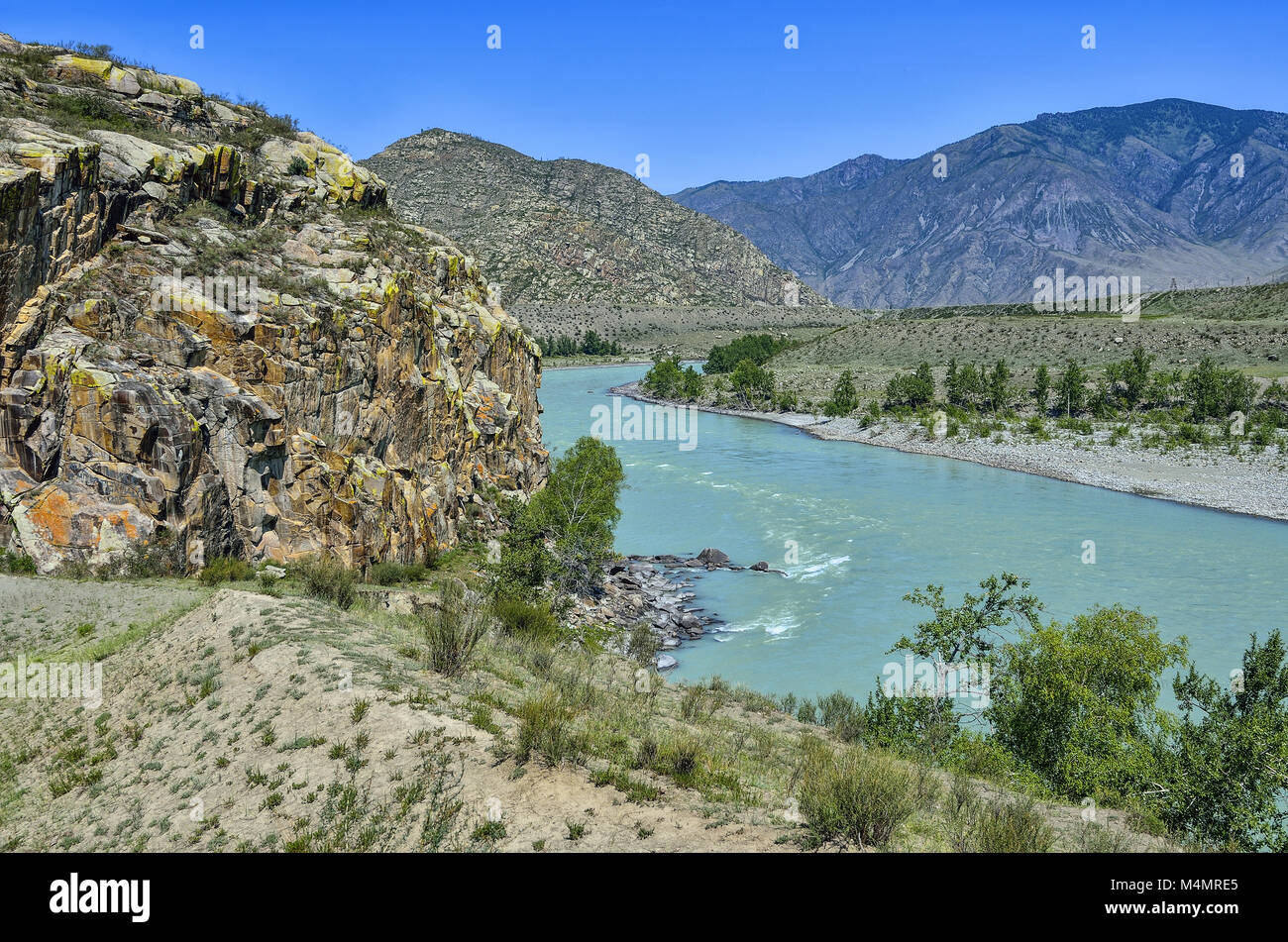 Summer mountain landscape with turquoise river and colorful rocks Stock Photo
